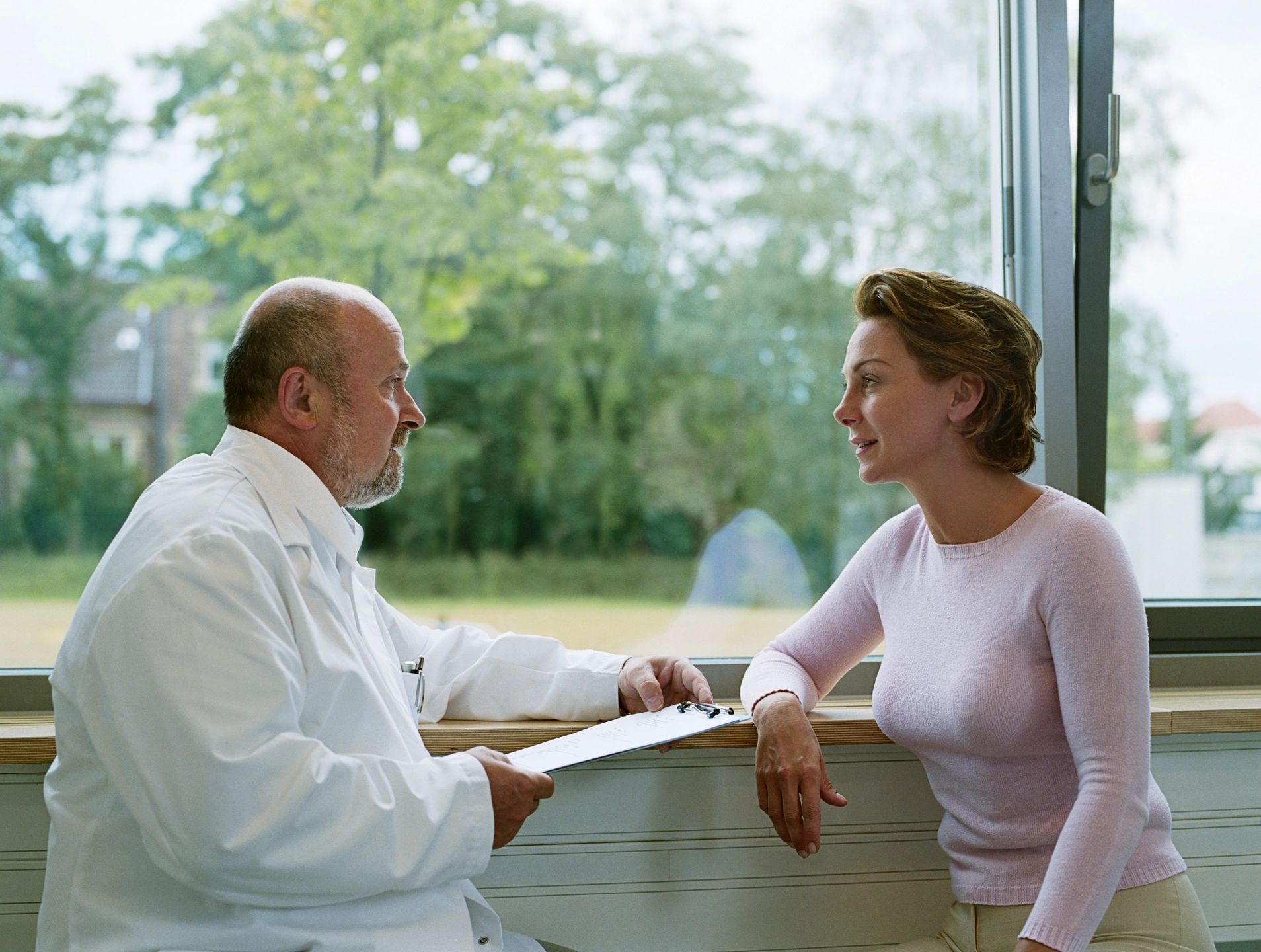 Bowen therapist consulting with patient